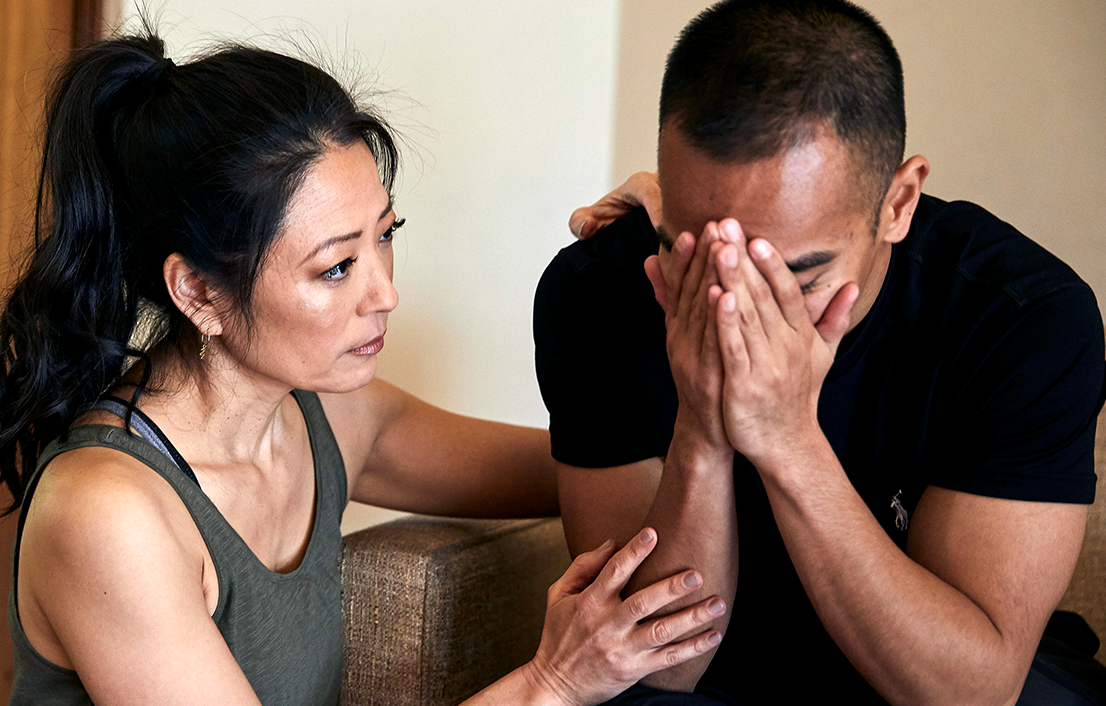 A woman and a man in a comforting or supportive interaction.