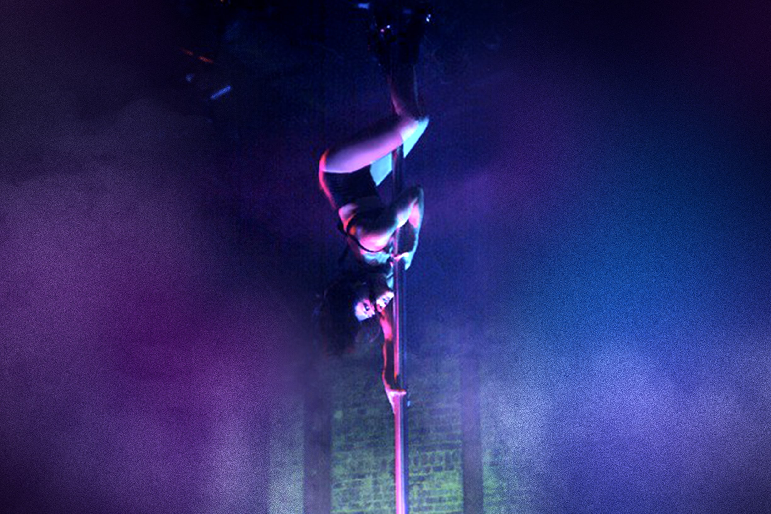 A dancer spinning on a pole in a vibrant club setting.