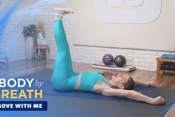 A woman performing a yoga or Pilates exercise.