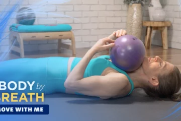 A woman performing a yoga or Pilates exercise.