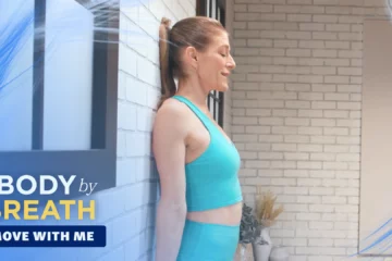 A woman performs axial rocking exercises on a wall.