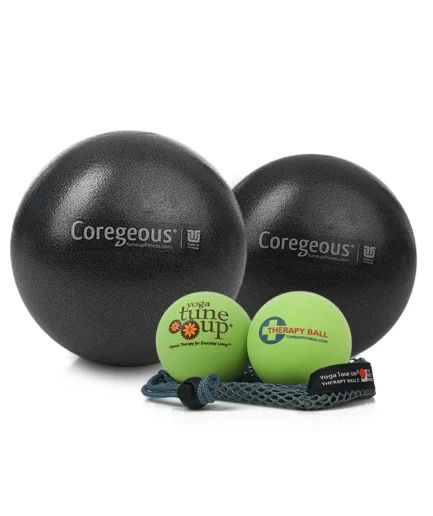A therapy ball set featuring two large black Coregeous Balls and a pair of small green therapy balls in a mesh tote