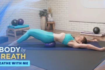 A woman is lying with her arms outstretched and her legs bent at the knees.