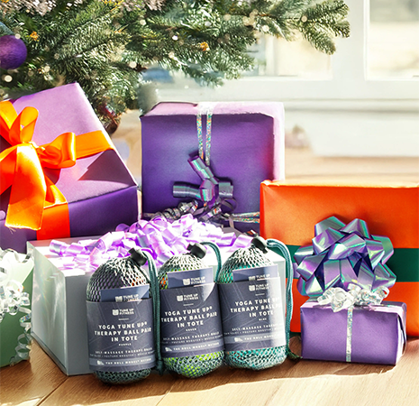 Featured Product Section Image #1 Tune Up Fitness therapy ball sets arranged with wrapped gifts and holiday decorations, highlighting festive self-care and wellness gifting.