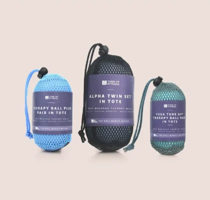 Rolls Royce Collection Three Tune Up Fitness Yoga Tune Up Therapy Ball Pairs in mesh totes, shown in purple and green, displayed alongside a Tune Up Fitness Quick Start Guide against a neutral background.