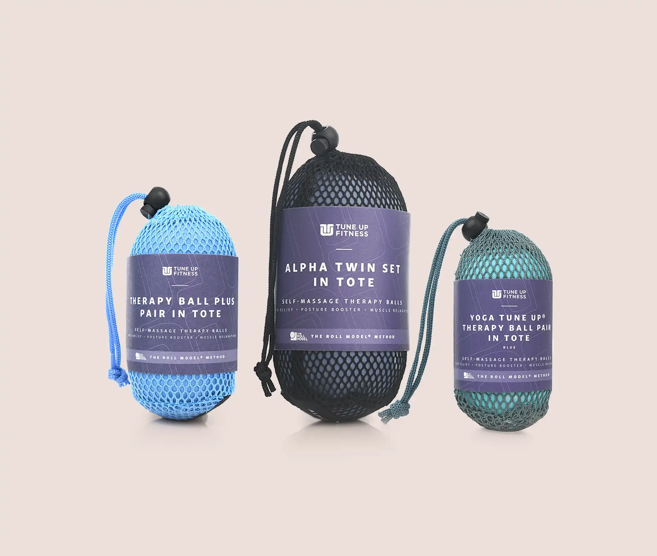 Rolls Royce Collection Three Tune Up Fitness Yoga Tune Up Therapy Ball Pairs in mesh totes, shown in purple and green, displayed alongside a Tune Up Fitness Quick Start Guide against a neutral background.