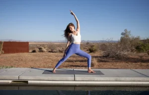 Woman in yoga pose within the desert.