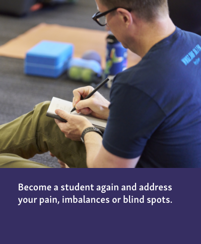 The man is actively engaged in taking notes.